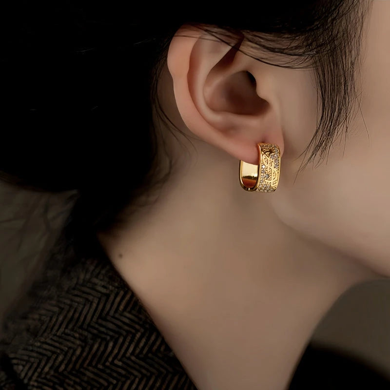Model showcasing the dangle and style of the 14K Gold-Plated Elegant Zircon Dollar Earrings