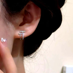 Model showcasing the dangle and style of the 14K Gold-Plated Elegant Zircon Double-Layer T Stud Earrings