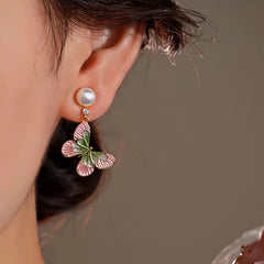 Model showcasing the dangle and style of the 14K Gold-Plated Elegant Zircon Enamel Butterfly Pearl Tassel Earrings