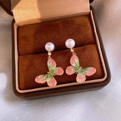 Angled view of the 14K Gold-Plated Elegant Zircon Enamel Butterfly Pearl Tassel Earrings