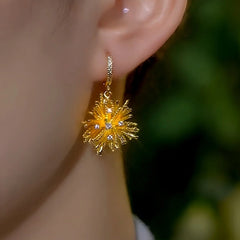 Model showcasing the dangle and style of the 14K Gold-Plated Elegant Zircon Firework Tassel Earrings