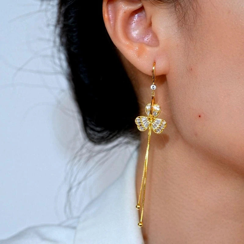 Model showcasing the dangle and style of the 14K Gold-Plated Elegant Zircon Flower Ear Hook Earrings