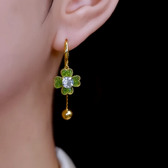 Close-up detail of the sparkling zircons and plating on the green flower earrings