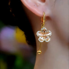 Model showcasing the dangle and style of the 14K Gold-Plated Elegant Zircon Flower Earrings