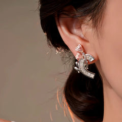 Model showcasing the dangle and style of the 14K Gold-Plated Elegant Zircon Flower Earrings