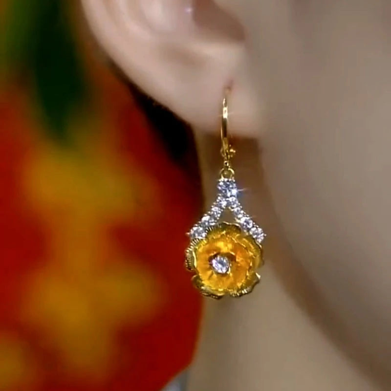 Close-up detail of the sparkling zircons and plating on the gold flower earrings
