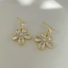 Close-up detail of the sparkling zircons and plating on the gold flower earrings