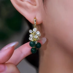 Close-up detail of the sparkling zircons and plating on the gold tassel earrings