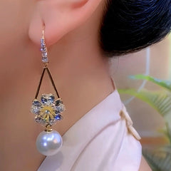 Close-up detail of the sparkling zircons and plating on the gold pearl earrings