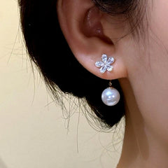 Close-up detail of the sparkling zircons and plating on the gold jacket earrings