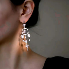Model showcasing the dangle and style of the 14K Gold-Plated Elegant Zircon Flower Tassel Earrings