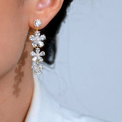 Model showcasing the dangle and style of the 14K Gold-Plated Elegant Zircon Flower Tassel Earrings
