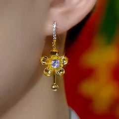 Model showcasing the dangle and style of the 14K Gold-Plated Elegant Zircon Flower Tassel Earrings