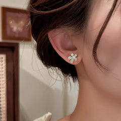 Close-up detail of the sparkling zircons and plating on the gold tassel earrings