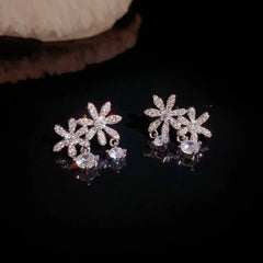 Angled view of the 14K Gold-Plated Elegant Zircon Flower Tassel Earrings