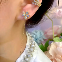 Close-up detail of the sparkling zircons and plating on the gold threader earrings