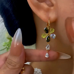 Model showcasing the dangle and style of the 14K Gold-Plated Elegant Zircon Flower Water Drop Tassel Earrings
