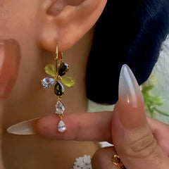 Close-up detail of the sparkling zircons and plating on the gold tassel earrings