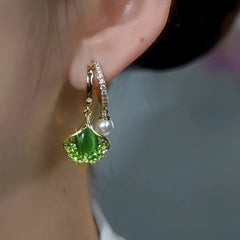 Close-up detail of the sparkling zircons and plating on the gold leaf earrings