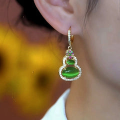 Model showcasing the dangle and style of the 14K Gold-Plated Elegant Zircon Gourd Earrings