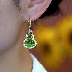 Close-up detail of the sparkling zircons and plating on the green drop earrings
