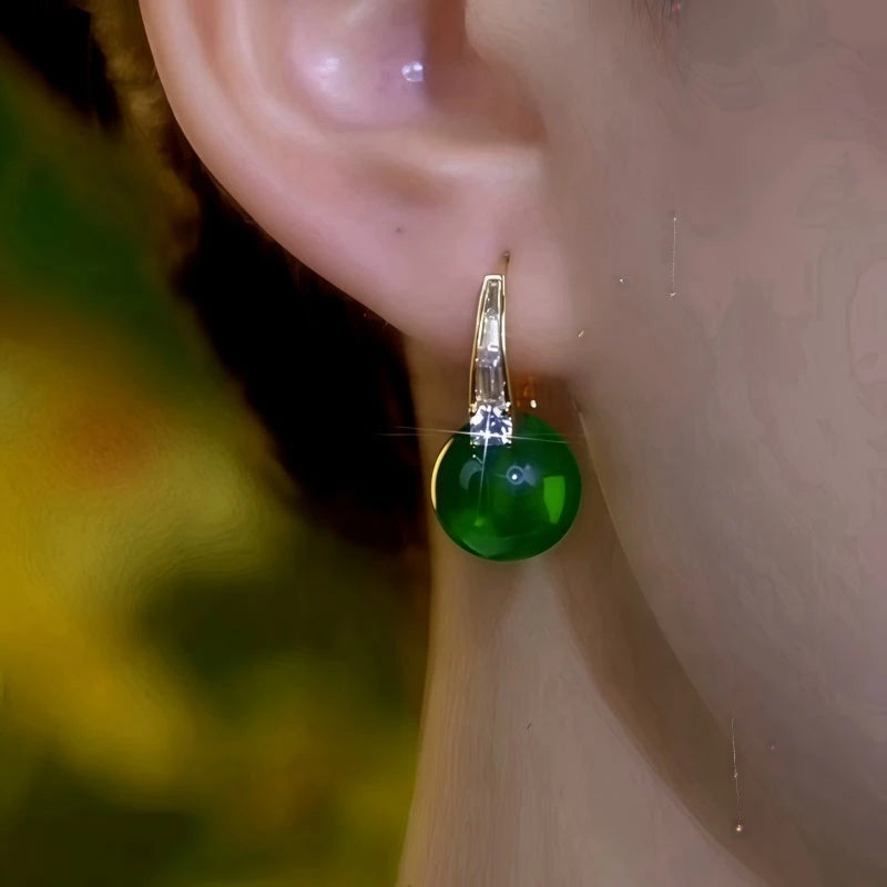Model showcasing the dangle and style of the 14K Gold-Plated Elegant Zircon Green Bead Earrings