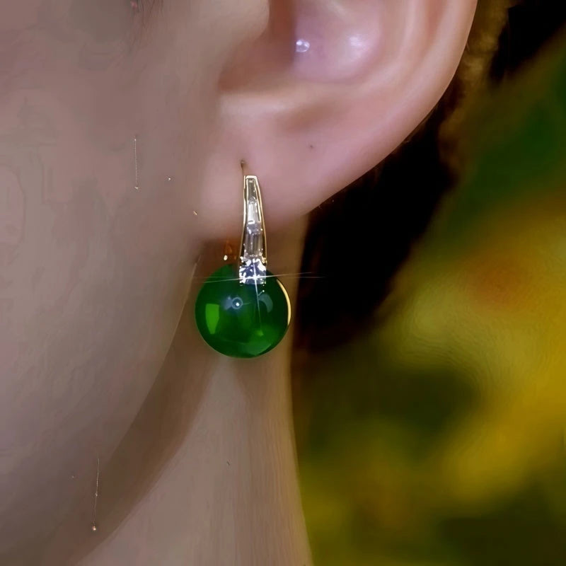 Close-up detail of the sparkling zircons and plating on the green drop earrings