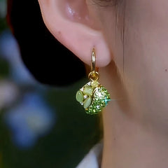 Model showcasing the dangle and style of the 14K Gold-Plated Elegant Zircon Green Cat's Eye Stone Diamond Earrings