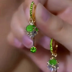 Close-up detail of the sparkling zircons and plating on the green tassel earrings