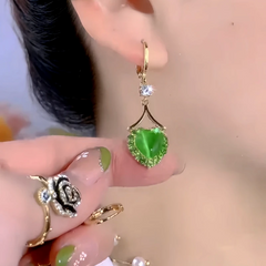 Angled view of the 14K Gold-Plated Elegant Zircon Green Heart Earrings