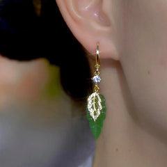 Model showcasing the dangle and style of the 14K Gold-Plated Elegant Zircon Green Leaf Earrings