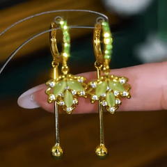 Close-up detail of the sparkling zircons and plating on the green leaf earrings