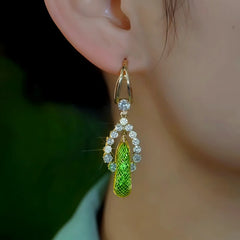 Model showcasing the dangle and style of the 14K Gold-Plated Elegant Zircon Green Mesh Crystal Tassel Earrings