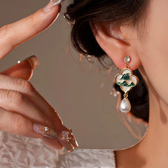 Close-up detail of the sparkling zircons and plating on the gold tassel earrings