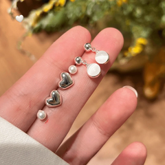 Model showcasing the dangle and style of the 14K Gold-Plated Elegant Zircon Heart Bead Earrings