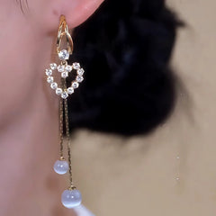 Close-up detail of the sparkling zircons and plating on the gold tassel earrings