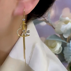 Close-up detail of the sparkling zircons and plating on the gold butterfly earrings