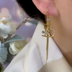 Model showcasing the dangle and style of the 14K Gold-Plated Elegant Zircon Heart Butterfly Tassel Ear Hooks