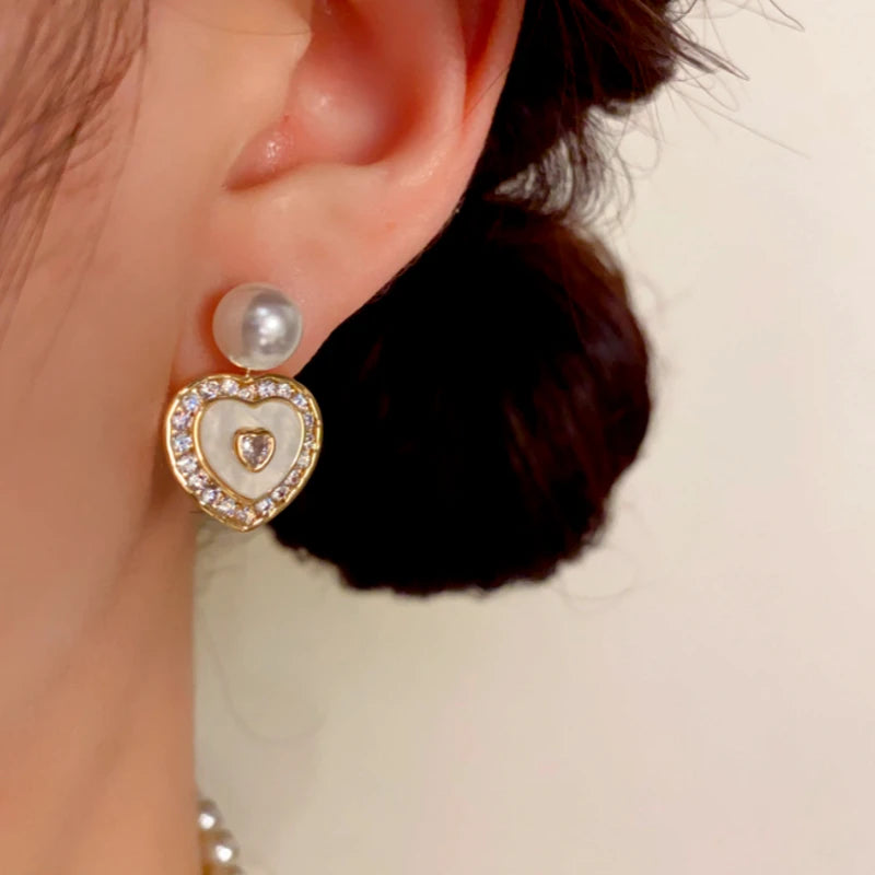 Close-up detail of the sparkling zircons and plating on the gold pearl earrings