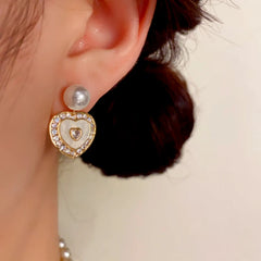 Close-up detail of the sparkling zircons and plating on the gold pearl earrings
