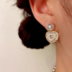 Model showcasing the dangle and style of the 14K Gold-Plated Elegant Zircon Heart Pearl Earrings