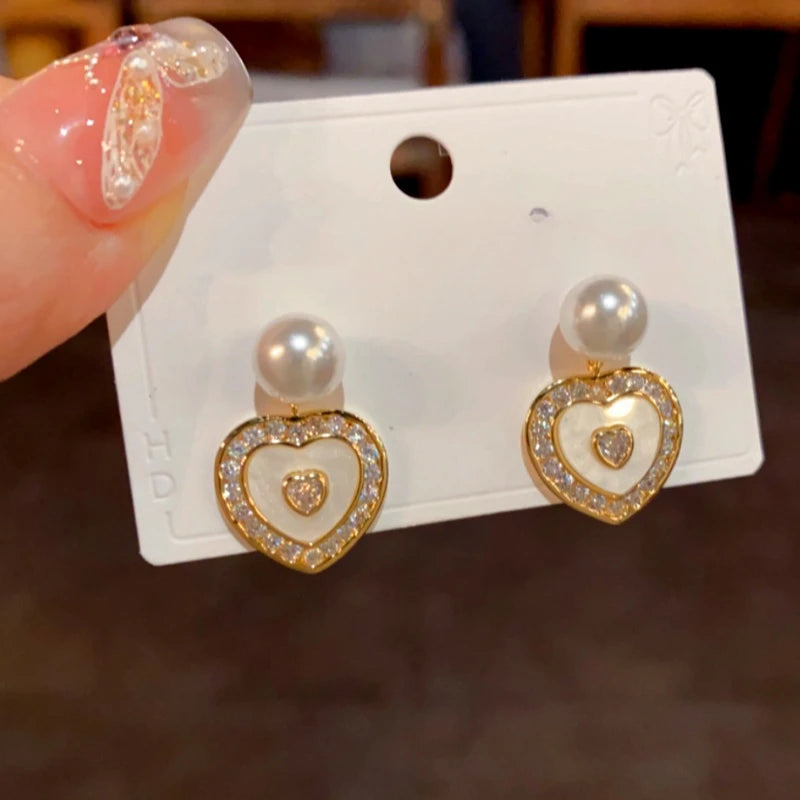 Angled view of the 14K Gold-Plated Elegant Zircon Heart Pearl Earrings