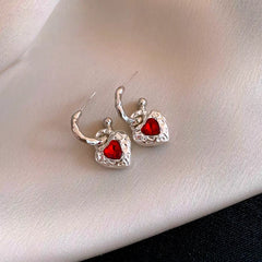 Close-up detail of the sparkling zircons and plating on the red heart earrings