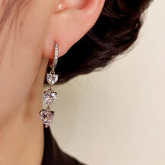 Close-up detail of the sparkling zircons and plating on the silver tassel earrings