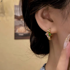 Model showcasing the dangle and style of the 14K Gold-Plated Elegant Zircon Hoop Earrings