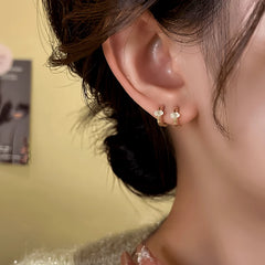 Model showcasing the dangle and style of the 14K Gold-Plated Elegant Zircon Hoop Earrings