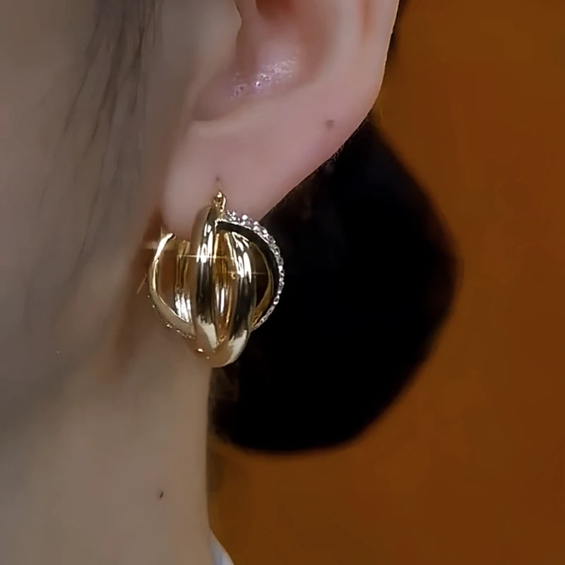 Close-up detail of the sparkling zircons and plating on the gold drop earrings