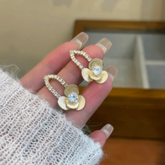 Angled view of the 14K Gold-Plated Elegant Zircon Jasmine Flower Earrings