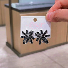 Close-up detail of the sparkling zircons and plating on the black flower earrings