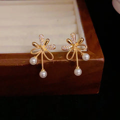 Close-up detail of the sparkling zircons and plating on the gold pearl earrings